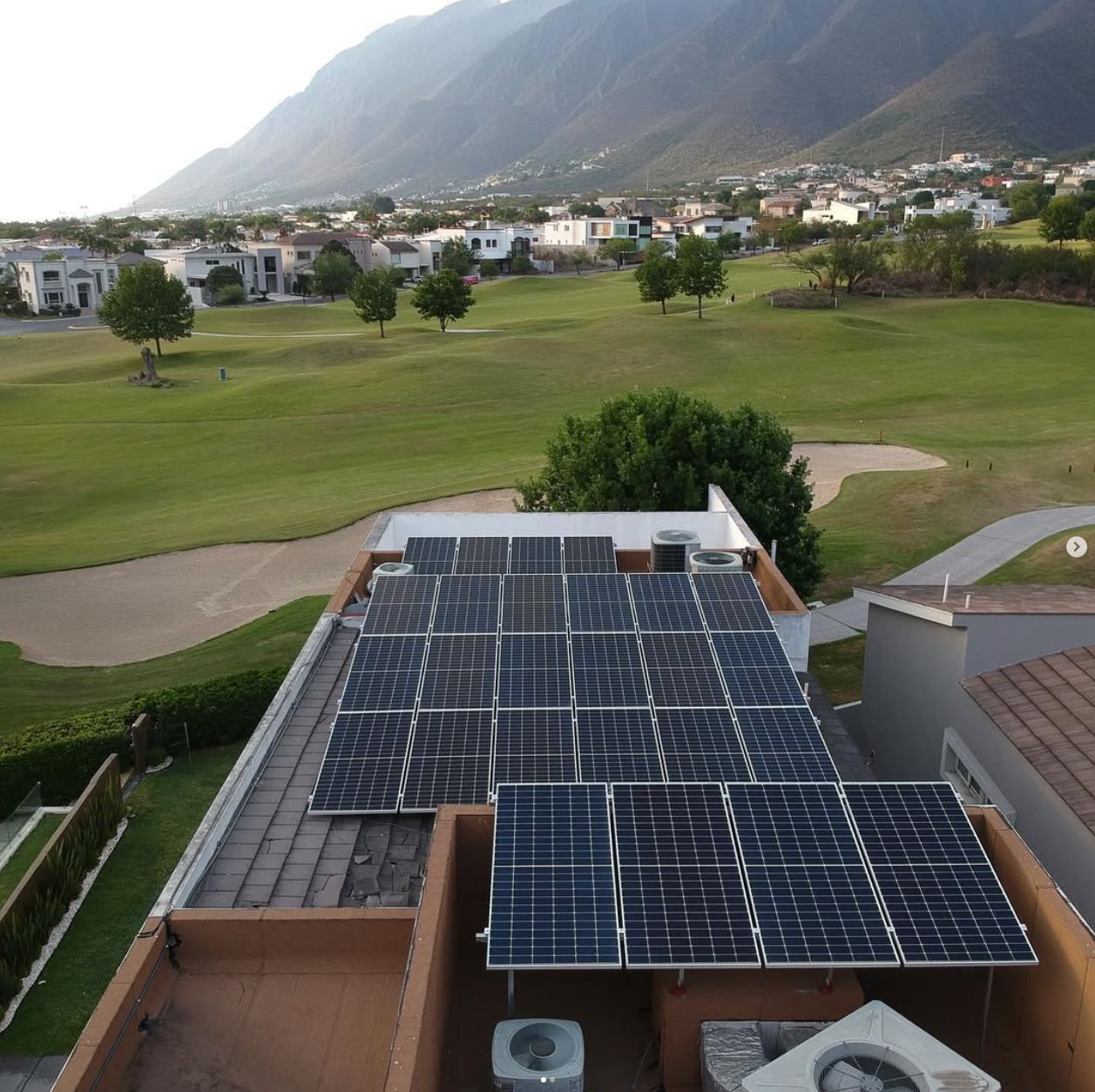 Paneles solares en residencia frente a campo de golf